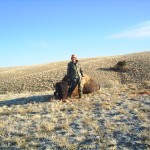 Hunter in Camo Posing Next to Buffalo
