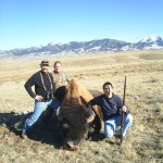 Three Hunters Posing Next to Buffalo